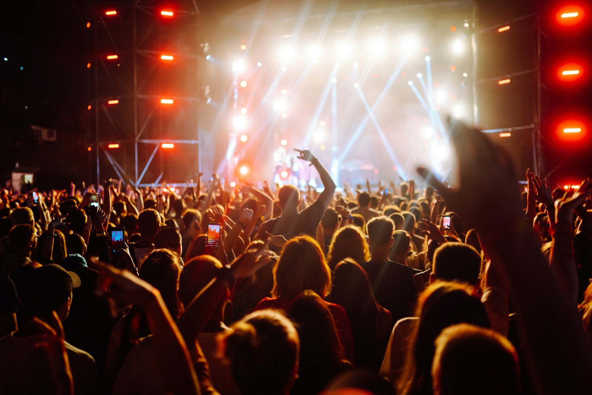 Use advanced mobile recording, fun concerts and beautiful lighting, Candid image of crowd at rock.