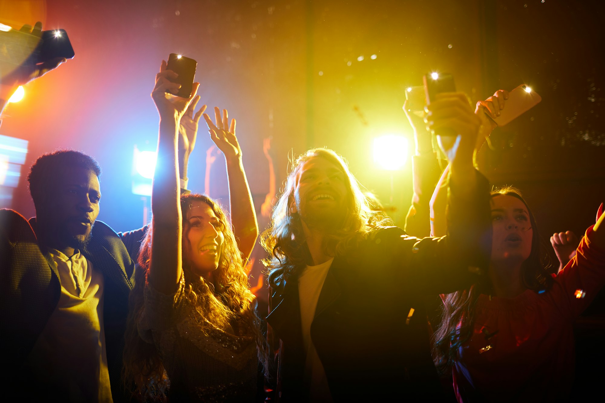 Jolly people screaming at musical concert